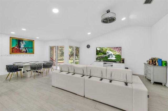 living room featuring vaulted ceiling