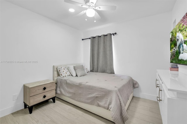 bedroom with ceiling fan and light wood-type flooring