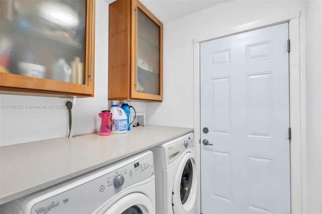 laundry room with cabinets and washing machine and dryer