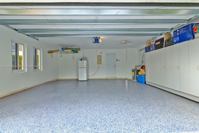 garage featuring a garage door opener, electric panel, and white fridge