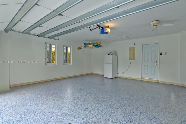 garage featuring a garage door opener, electric panel, and white refrigerator