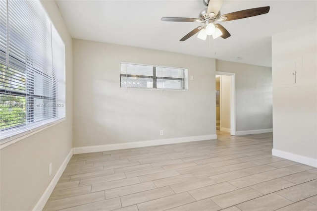 empty room featuring ceiling fan, light hardwood / wood-style flooring, and a wealth of natural light