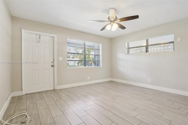 empty room with ceiling fan and light hardwood / wood-style floors