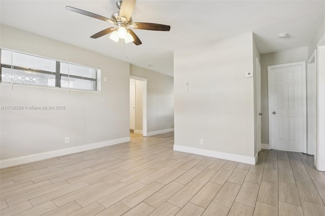 empty room with ceiling fan and light wood-type flooring