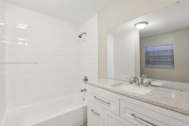 bathroom with vanity and tiled shower / bath