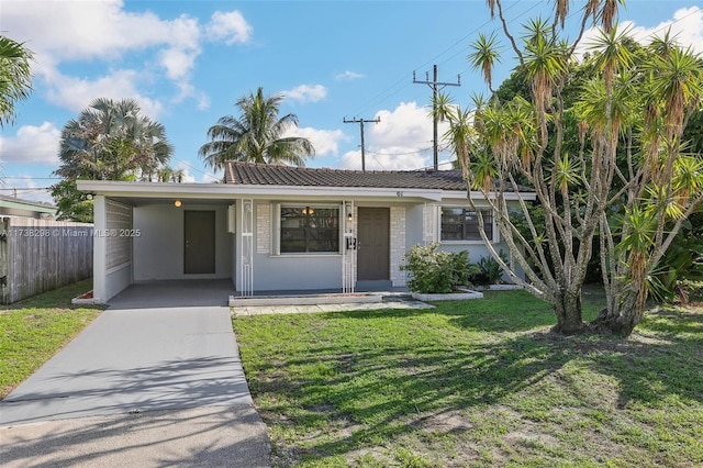 view of front of property with a front yard and a carport