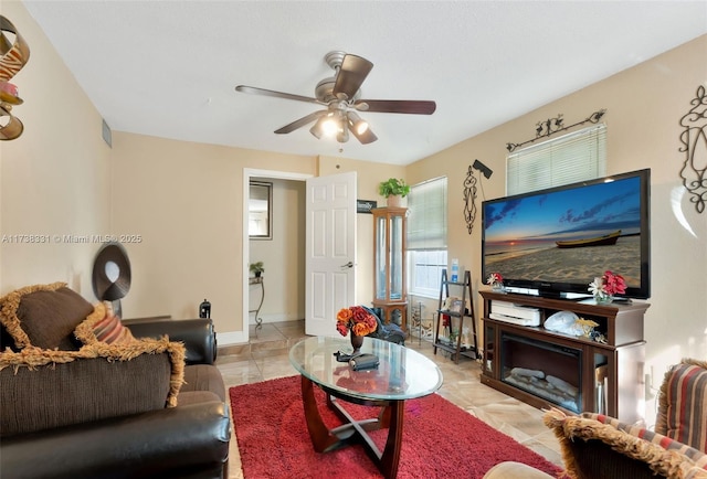 living room featuring light tile patterned floors and ceiling fan