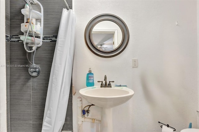 bathroom featuring sink and curtained shower