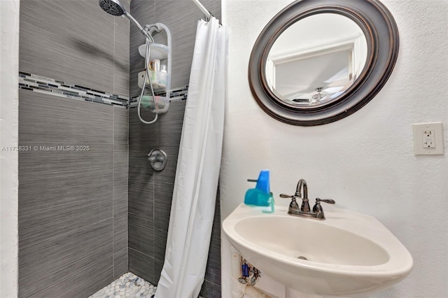 bathroom featuring sink and a shower with curtain