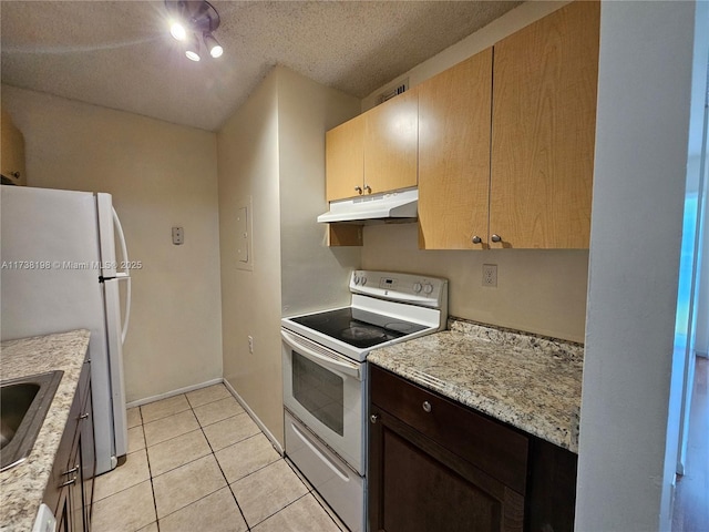 kitchen with sink, a textured ceiling, light tile patterned floors, white appliances, and light stone countertops