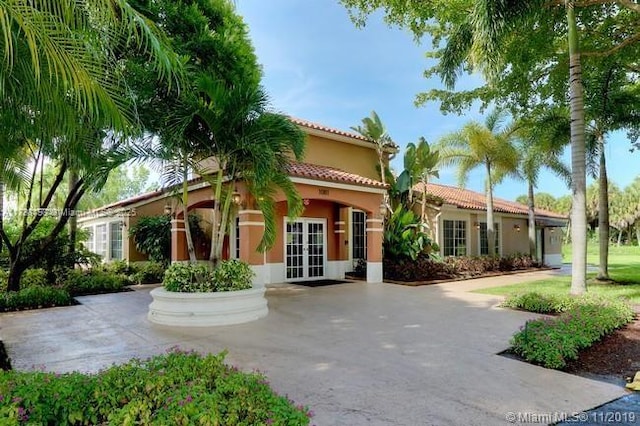 mediterranean / spanish home featuring french doors