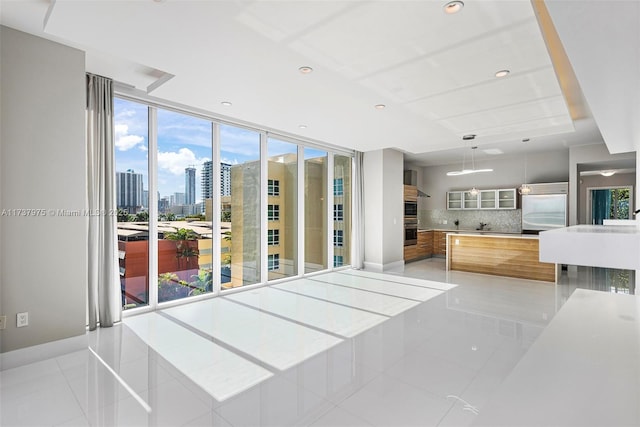 interior space featuring light tile patterned floors and stainless steel built in refrigerator