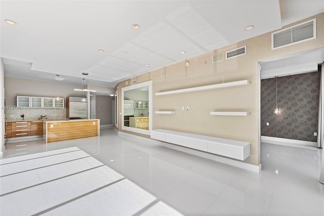 kitchen featuring light tile patterned flooring, decorative light fixtures, and stainless steel built in fridge