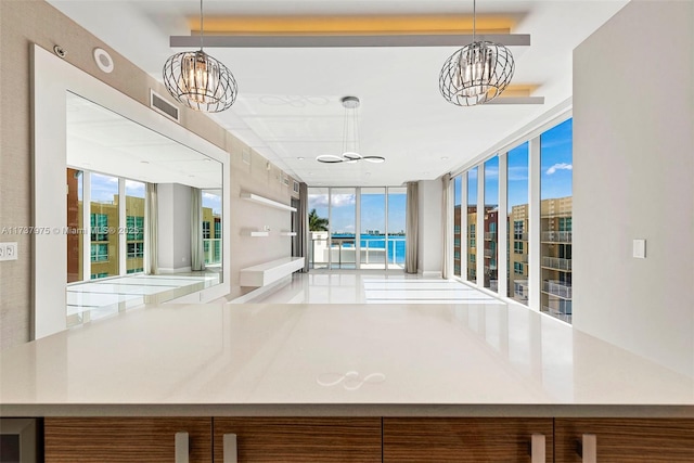 interior space with a wall of windows and a notable chandelier