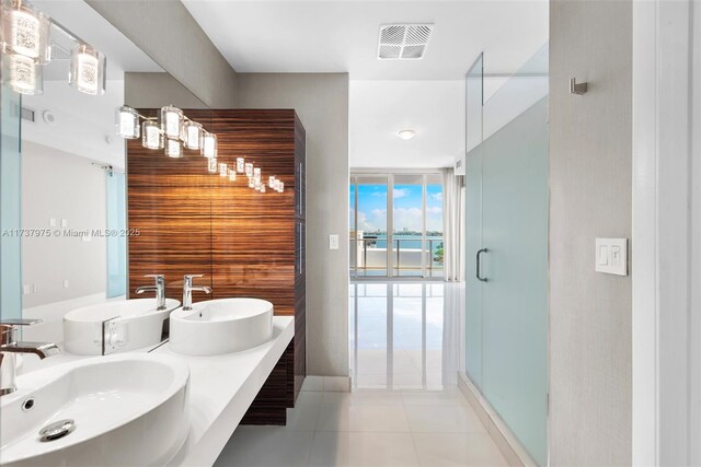 bathroom with vanity, tile patterned floors, a shower with door, and floor to ceiling windows