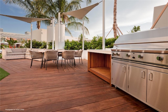 wooden deck featuring an outdoor living space and an outdoor kitchen