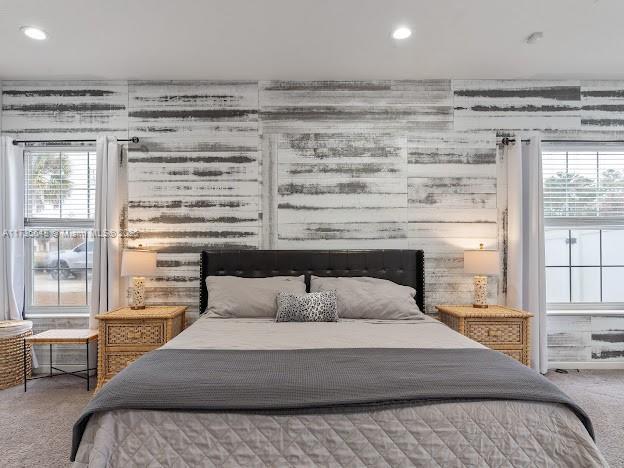 bedroom with multiple windows and carpet floors