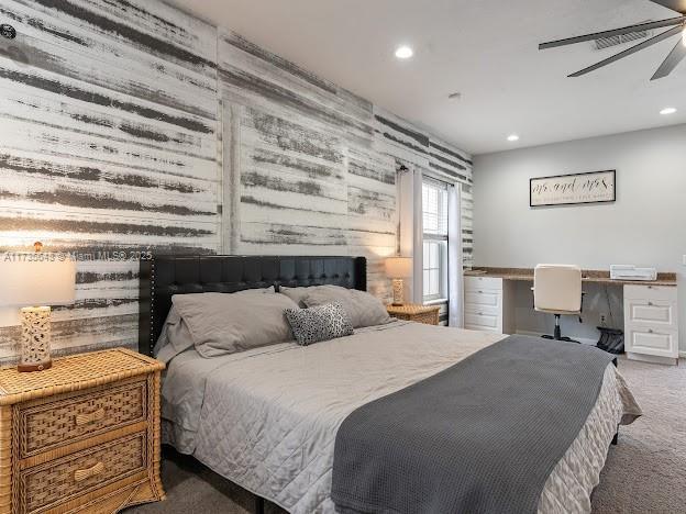 bedroom featuring carpet floors, built in desk, and ceiling fan