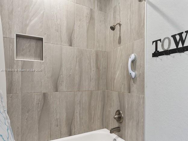 room details with shower / bath combination with curtain