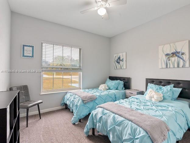 bedroom with ceiling fan and carpet flooring