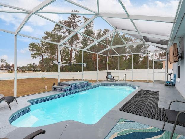 view of swimming pool with a lanai, a jacuzzi, and a patio area