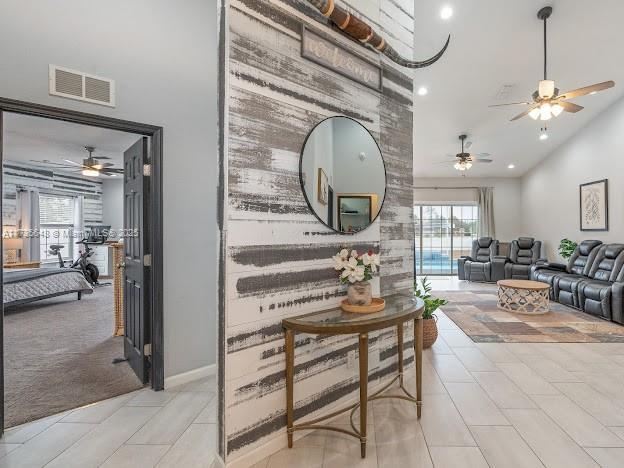 interior space featuring light tile patterned flooring, high vaulted ceiling, and a wealth of natural light