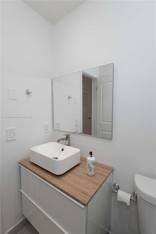 bathroom featuring vanity and toilet