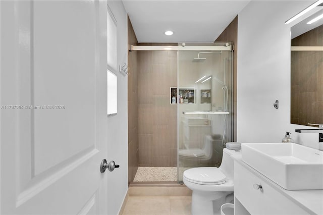 bathroom with tile patterned flooring, vanity, toilet, and an enclosed shower