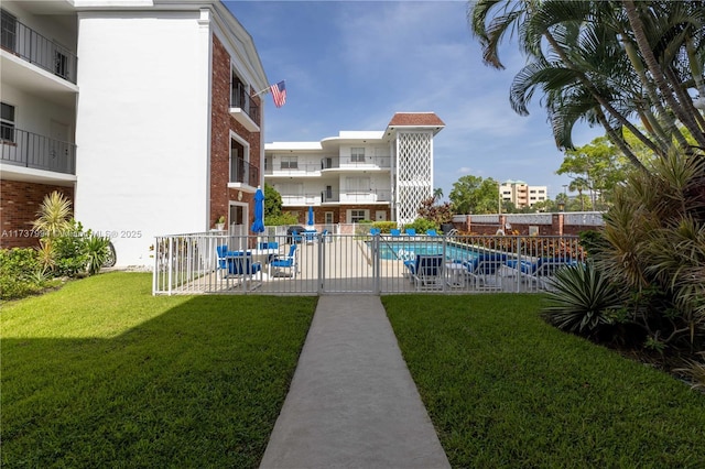 view of pool with a yard