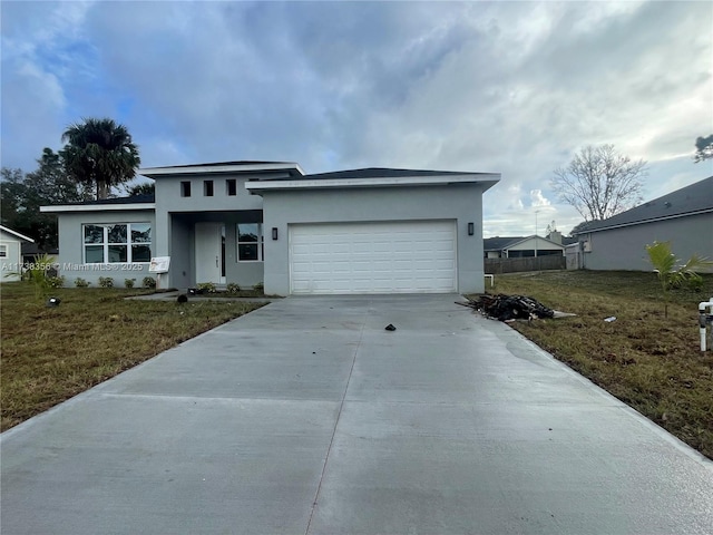 view of front facade with a garage and a front lawn