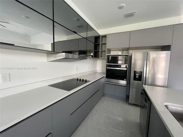 kitchen featuring visible vents, gray cabinets, appliances with stainless steel finishes, modern cabinets, and open shelves