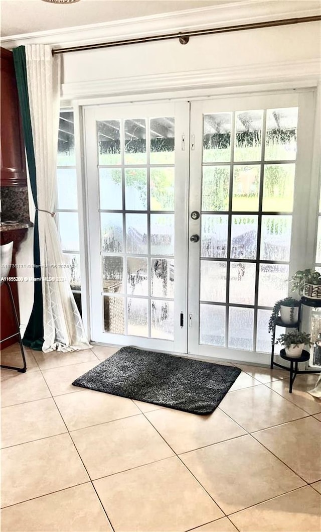 doorway to outside featuring light tile patterned floors and french doors