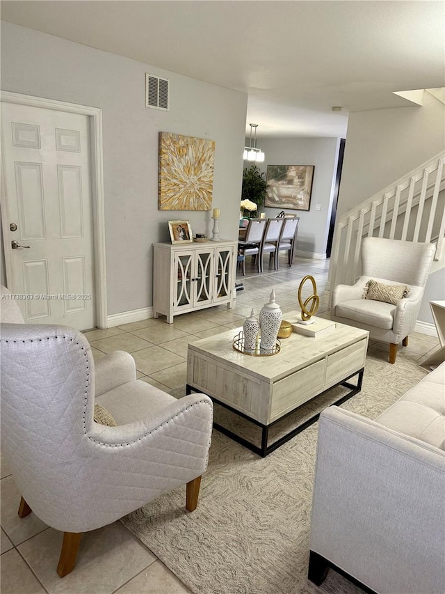 living room featuring tile patterned floors and an inviting chandelier