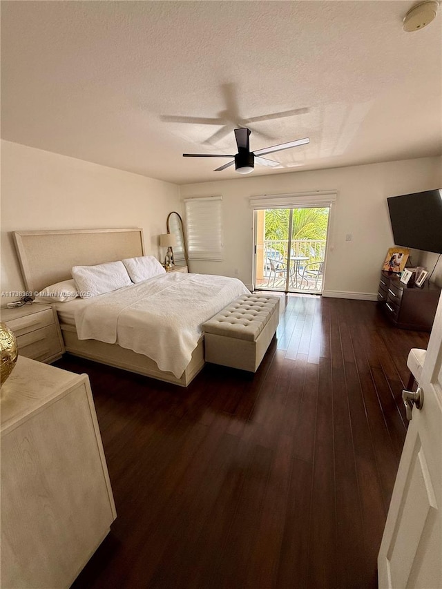 bedroom with dark wood-type flooring, ceiling fan, a textured ceiling, and access to outside