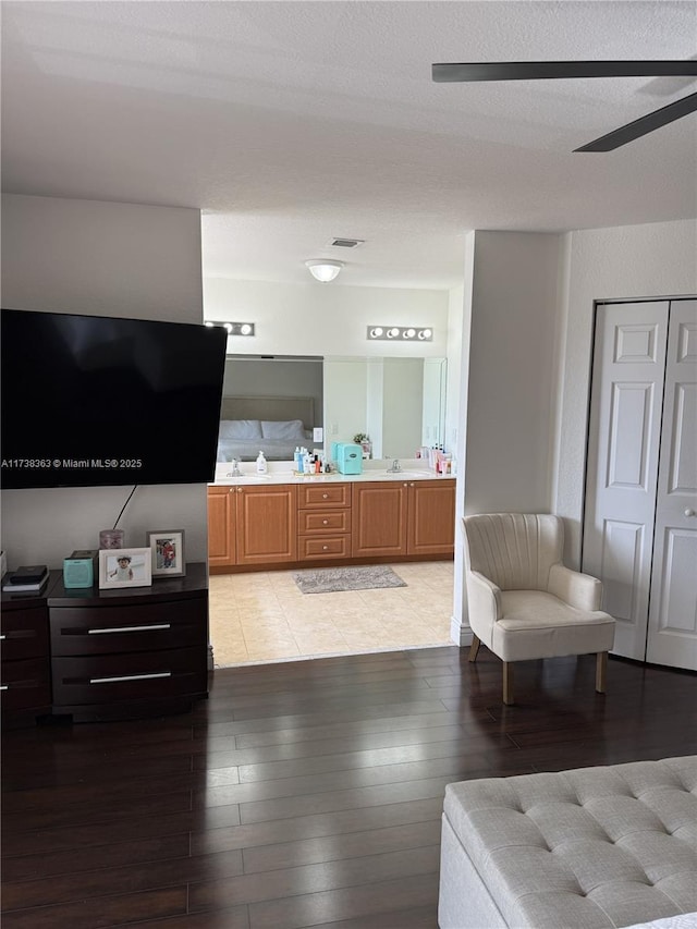 interior space with ceiling fan, vanity, and hardwood / wood-style floors