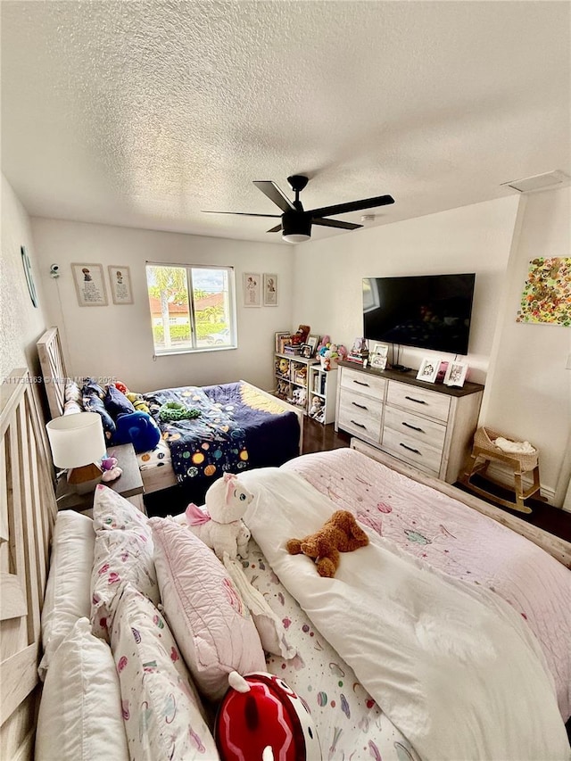 bedroom with a textured ceiling and ceiling fan