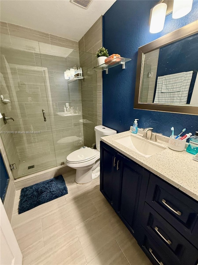 bathroom featuring walk in shower, vanity, and toilet