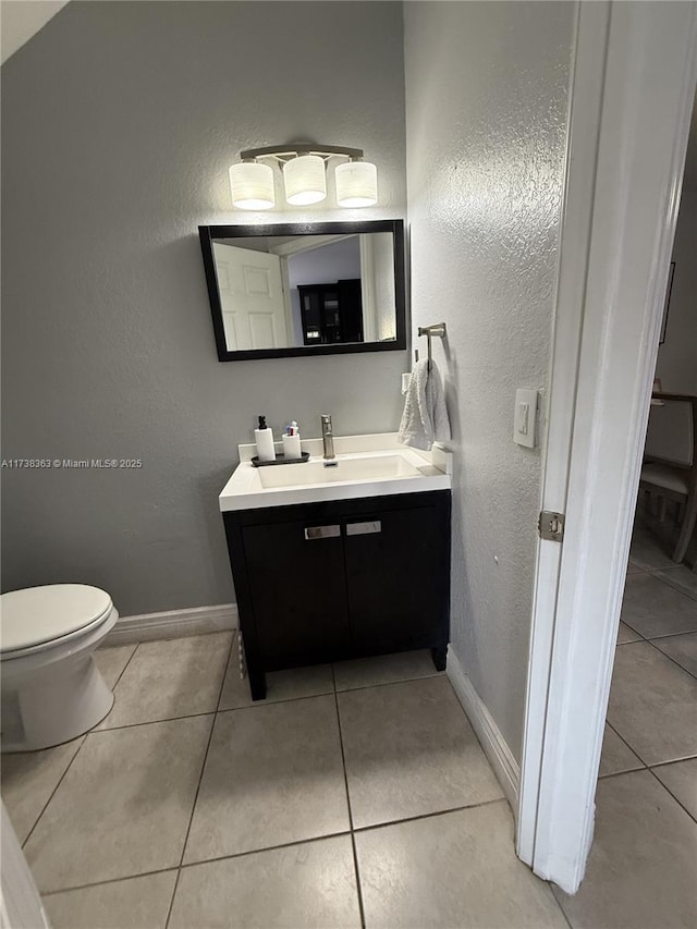 bathroom with vanity, tile patterned floors, and toilet