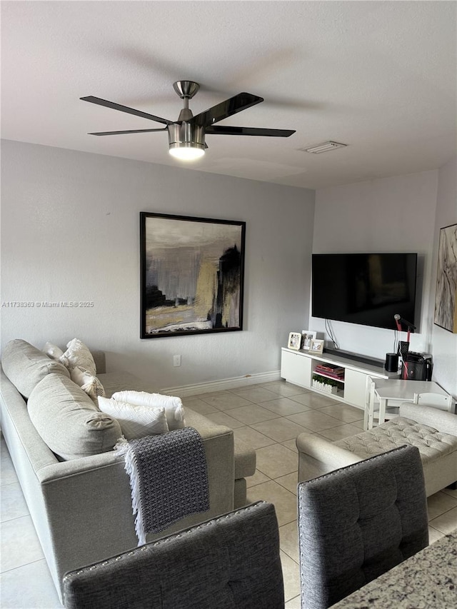 tiled living room featuring ceiling fan