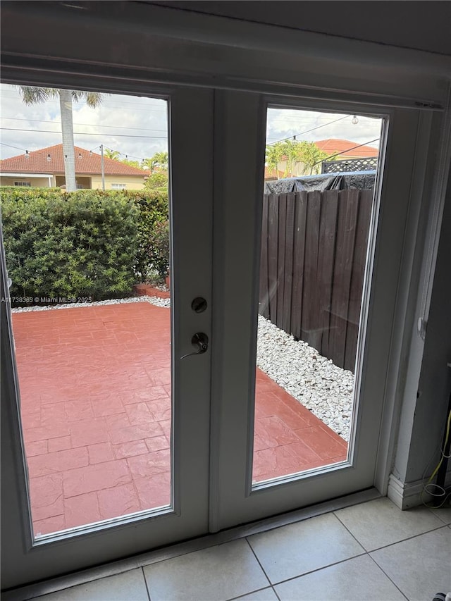 doorway with tile patterned flooring