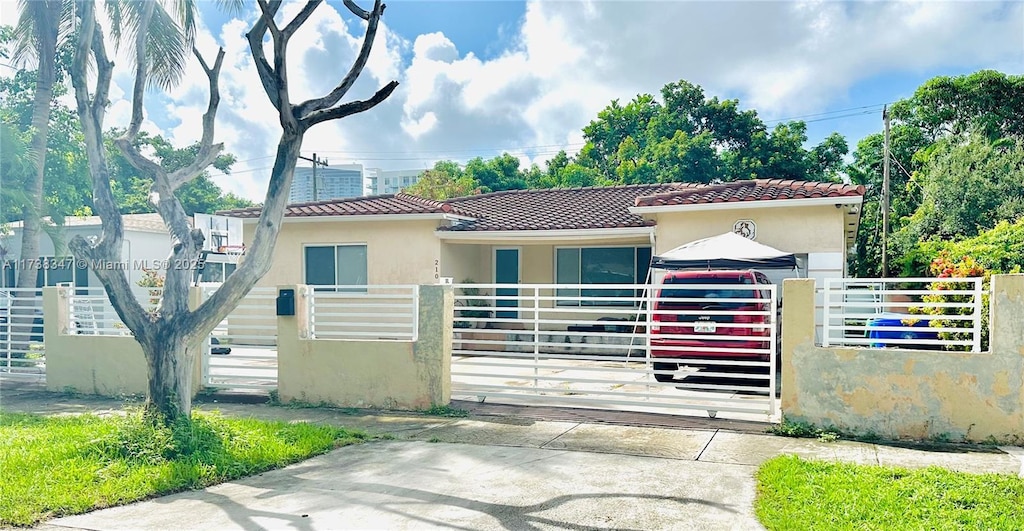 view of gate with a fenced front yard