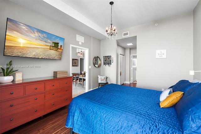 bedroom with dark hardwood / wood-style flooring, a closet, and a notable chandelier