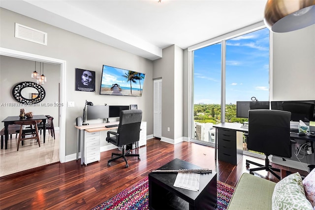 office area with dark wood-type flooring and floor to ceiling windows