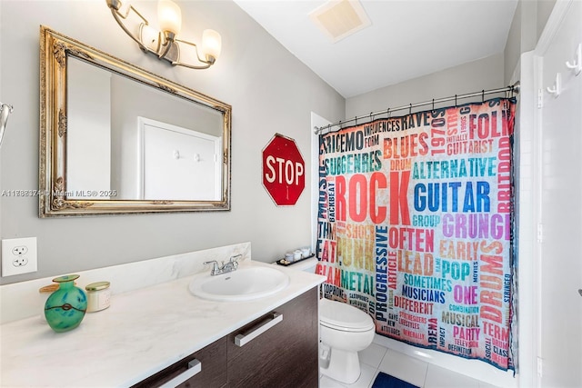 bathroom featuring vanity, toilet, and tile patterned flooring