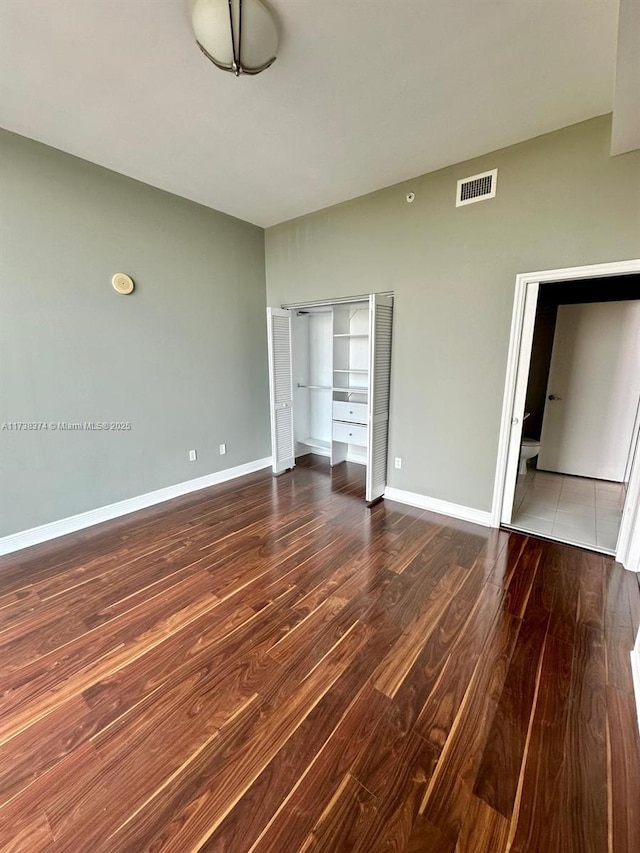 unfurnished bedroom featuring hardwood / wood-style flooring and a closet