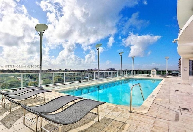 view of swimming pool with a patio area