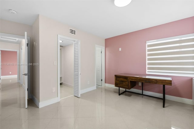 home office with light tile patterned floors