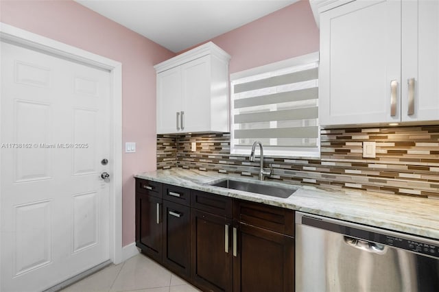 kitchen featuring sink, tasteful backsplash, dishwasher, light stone countertops, and white cabinets