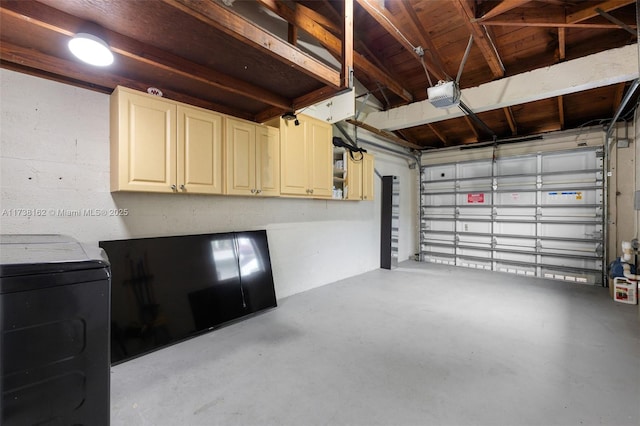 garage featuring a garage door opener and washer / dryer