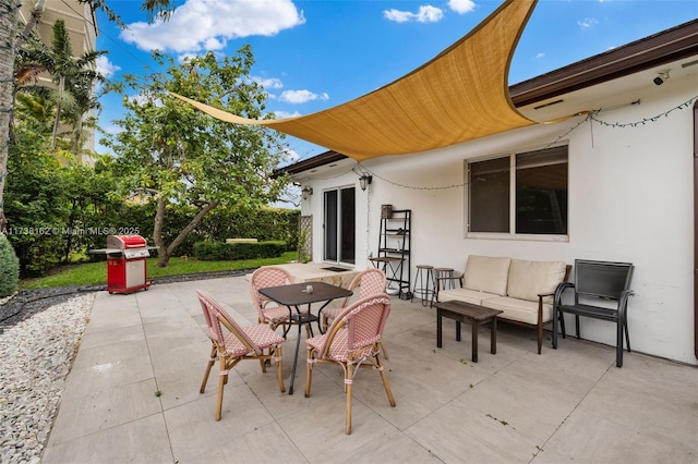 view of patio with a grill and an outdoor hangout area